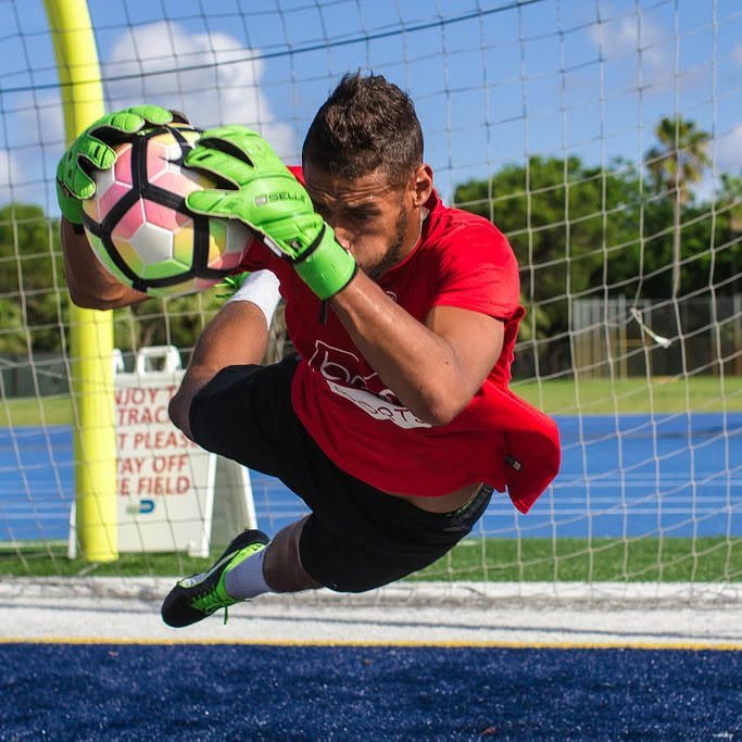 Sidi making a diving save, catching the ball